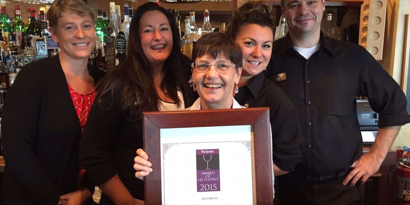 Mirror Lake Inn team holding a Wine Spectator award