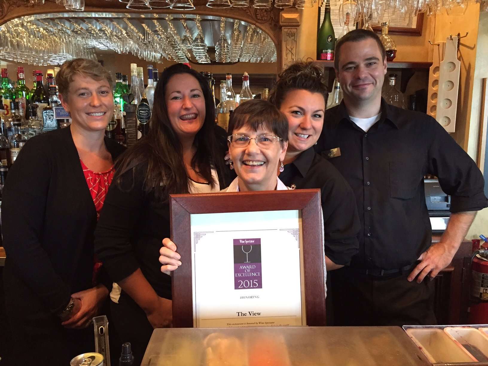 Mirror Lake Inn team holding a Wine Spectator award