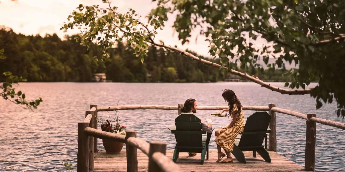 A couple sitting on chairs on the dock