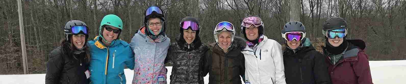 Women skiers posing for picture