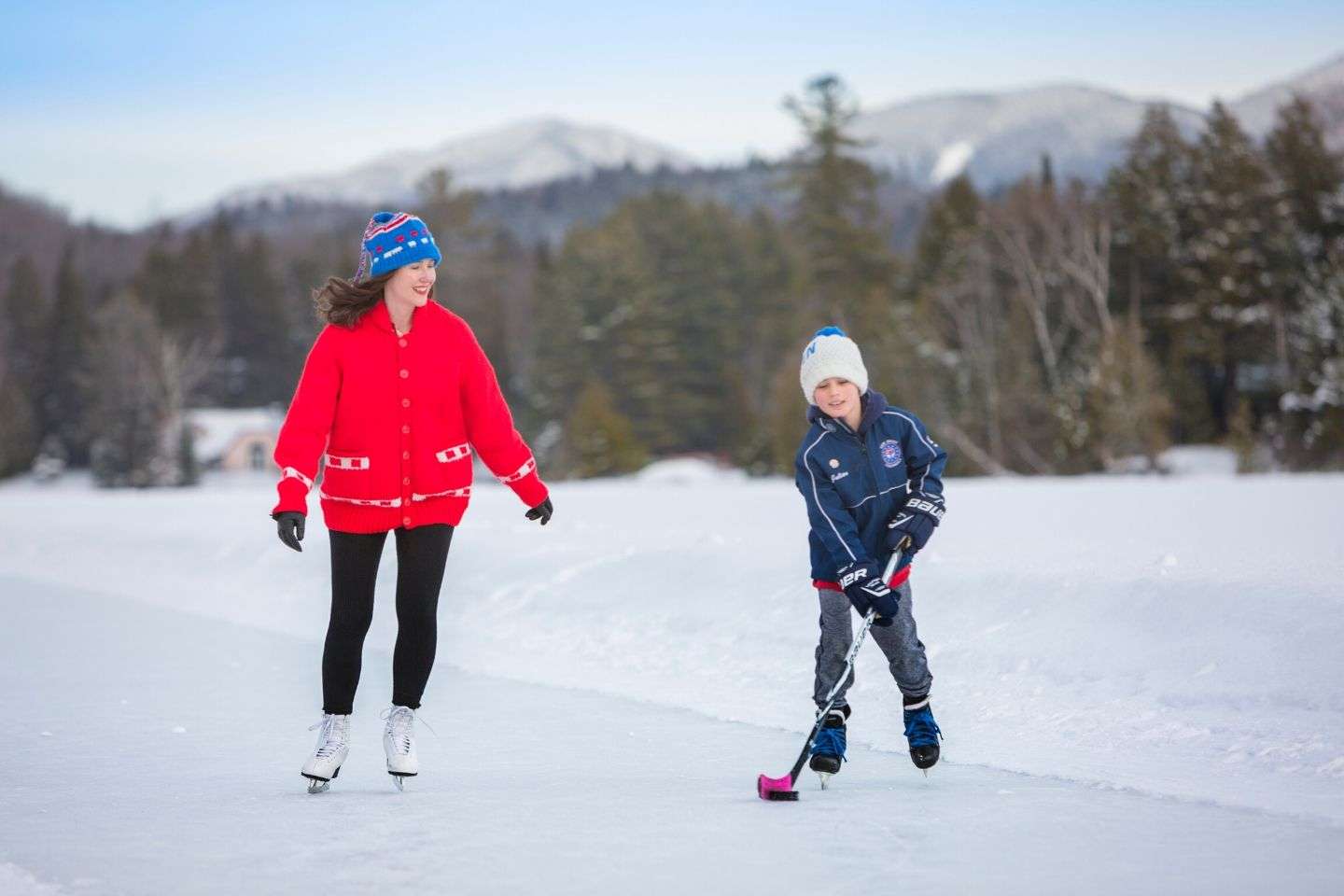 Woman skating beside her son on Mirror Lake