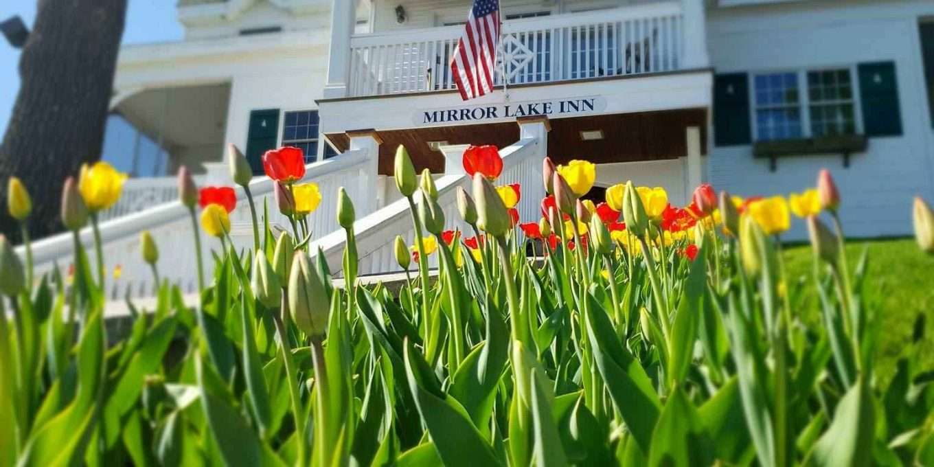 Red and yellow tulips in front of the entrance to Mirror Lake Inn