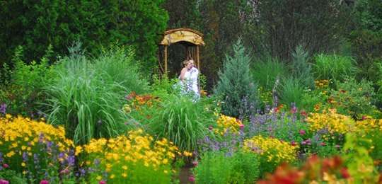 Bride and Groom standing in wedding gardens