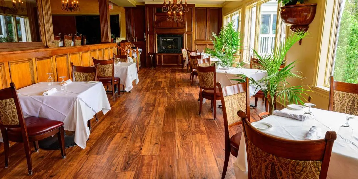 A bright dining room with wood floor and paneling at The View restaurant