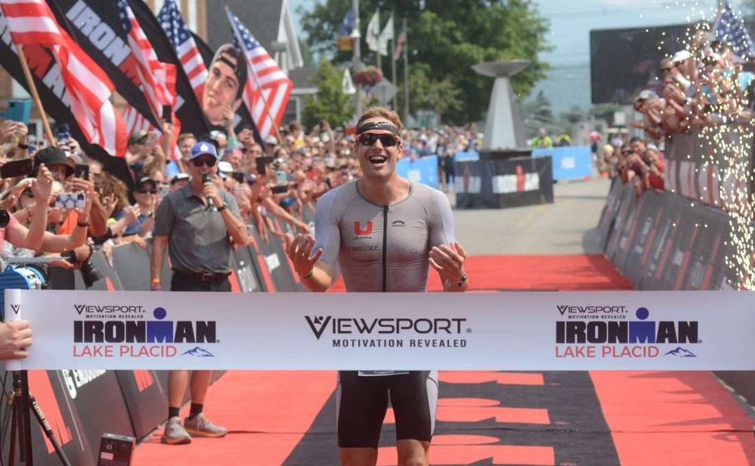 Triathlete crosses finish line