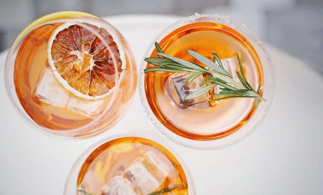 directly look from above of three cocktails on white table clothes