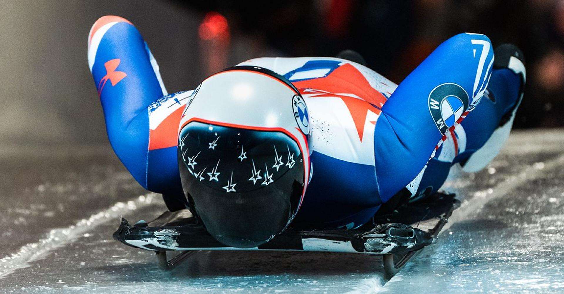 Person in Olympic uniform on Skeleton at Mt. Vanhoevenberg