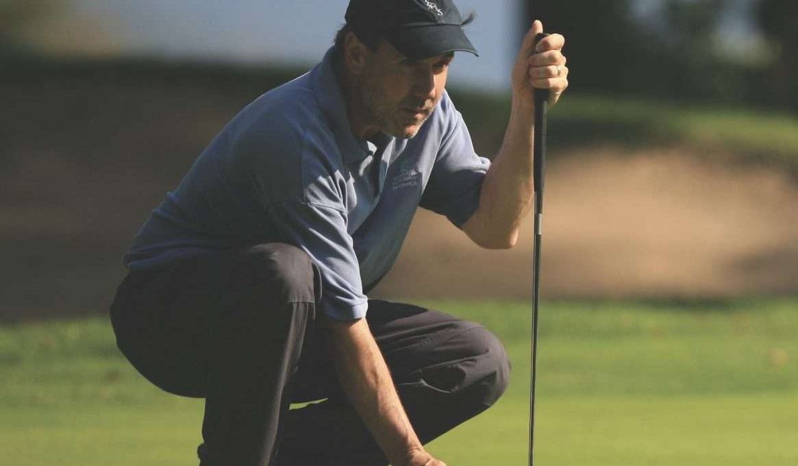 Man preparing to make a putt