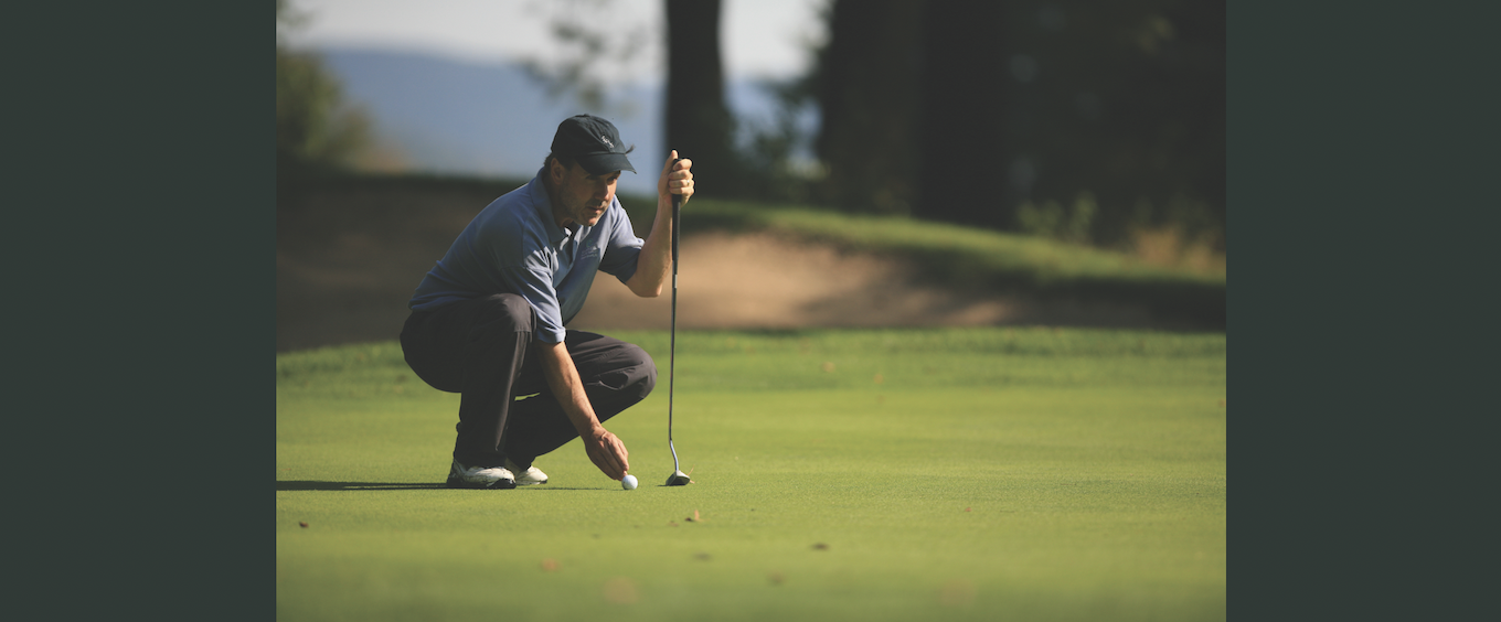 man setting up a putt
