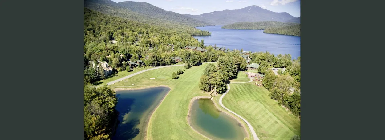 aerial view of golf course and mountains