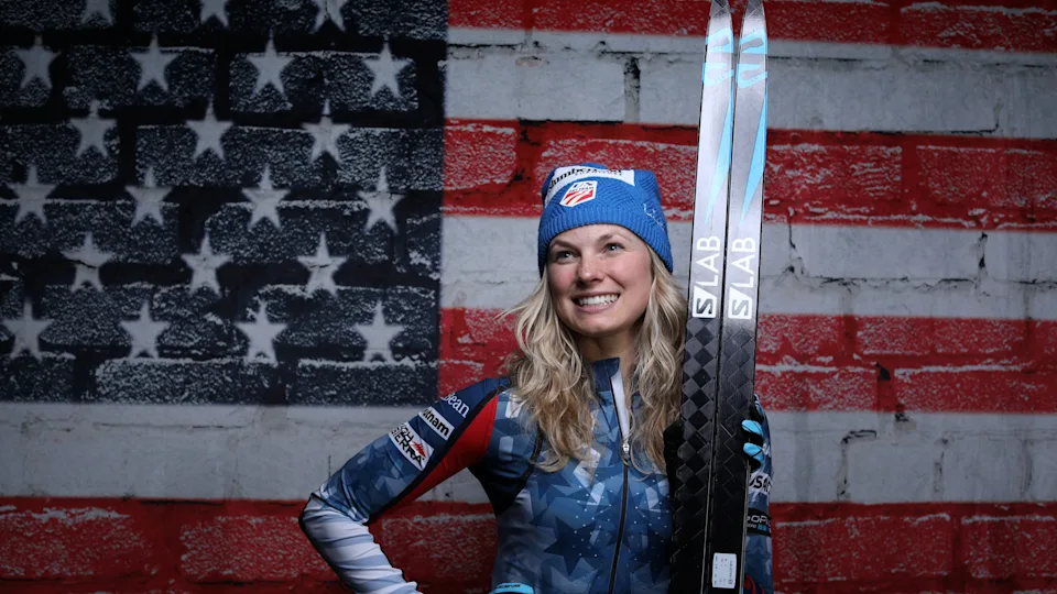 Skier posing in front of US flag