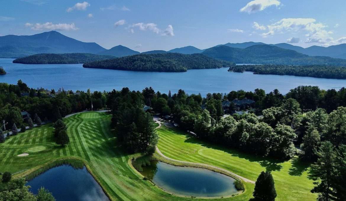 Aerial image of the golf course showing lake and mountains