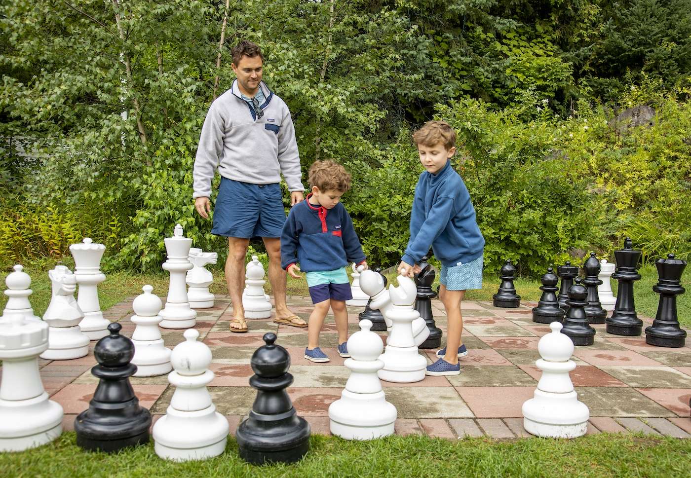 Family playing giant chess